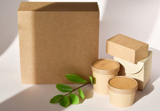 cardboard-box-with-disposable-containers-green-sprig_261761-824