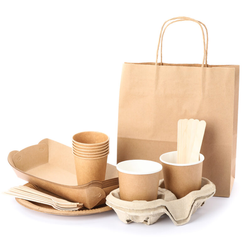 Eco - friendly tableware and paper bag isolated on white backgro